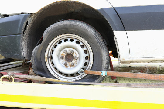 Car is on tow truck with flat tire. Car evacuation and transportation concept