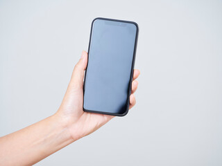 Woman holding smartphone with blank screen