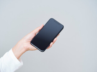 Woman holding smartphone with blank screen