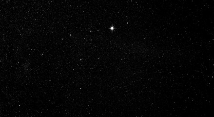 Fototapeta premium Leuchtender Stern im Sternenhimmel