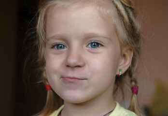 Close-up portrait of adorable smiling little girl. Selective focus with shallow depth of field.