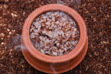 Rice porridge, Kanji, gruel in clay pot palm mat background Kerala South India .congee, rice soup, green gram curry, chammanthi. Ayurveda diet  for immunity. Top view porridge Indian veg food.