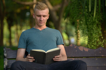 Young man with blond hair at the park outdoors