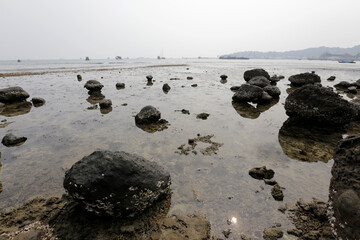 Rocks on a beach in the area of ​​Padang, West Sumatra, Indonesia. October 3, 2015