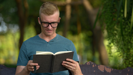 Fototapeta premium Young man with blond hair at the park outdoors