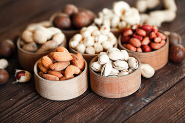 Fototapeta na wymiar Assorted nuts for a background Almond, walnut,cashew, pistachios, hazelnuts, peanuts, Macadamia Collection of different varieties of nuts. Composition with dried fruits Healthy food. Organic.