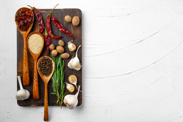 Red chili peppers and other spices on white textured background, top view
