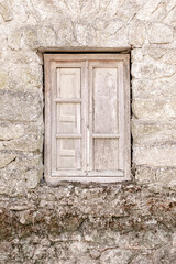 rustic wooden window in old stone house