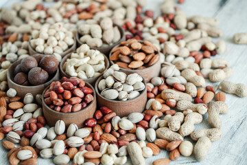 Fototapeta premium Assorted nuts for a background Almond, walnut,cashew, pistachios, hazelnuts, peanuts, Macadamia Collection of different varieties of nuts. Composition with dried fruits Healthy food. Organic.