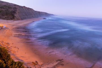 Magical beautiful Sunset at Rocky beach with Blue Ocean. Coastline landscape. Beautiful Scenic View. Magoito Beach, Sintra, Portugal