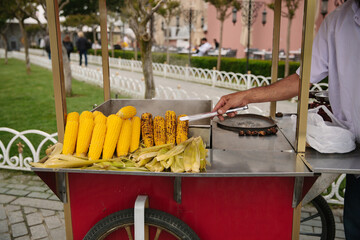 A seller of sweet corn in Turkey . Street food of Istanbul.