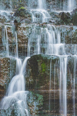 Majestic waterfall in deep forest. River forest scene. Wild, vivid vegetation. Beautiful landscape in Sintra, Portugal