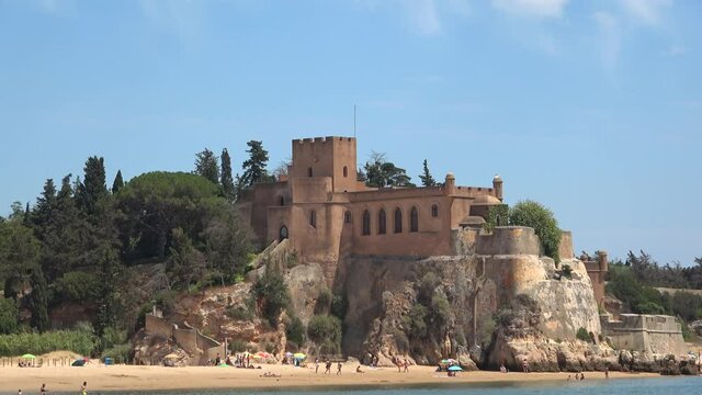 View of Castle of Arade from a sightseeing speedboat, with the wobble of the ship. Medieval fortification situated in the civil parish of Ferragudo in the Portuguese Algarve municipality of Lagoa.