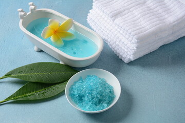 Obraz na płótnie Canvas Spa and body care products. Aromatic blue bath Dead Sea Salt on the blue background. Natural ingredients for homemade body salt scrub. Dead Sea cosmetics. Beauty skin care. Spa treatment. 