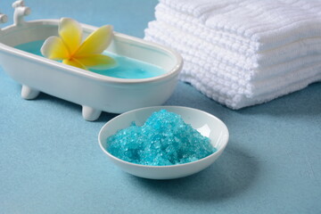 Spa and body care products. Aromatic blue bath Dead Sea Salt on the blue  background. Natural ingredients for homemade body salt scrub. Dead Sea cosmetics. Beauty skin care. Spa treatment. 
