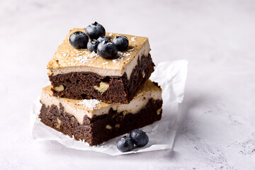 Pieces of Homemade Chocolate Brownies Decorated with Ripe Blueberry on Gray Background Tasty Chocolate Dessert Copy Space