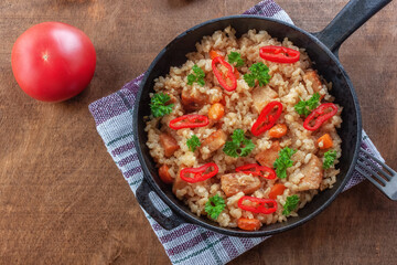 Rice with meat, vegetables and parsley in a serving pan