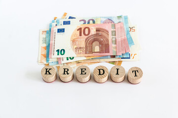 Word "loan" written with wooden blocks on white background "kredit" means "loan" in german