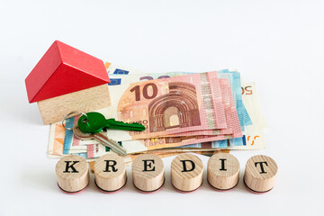 Word "loan" written with wooden blocks on white background "kredit" means "loan" in german