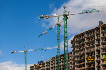 construction site with cranes against the blue sky