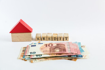 Word "loan" written with wooden blocks on white background "kredit" means "loan" in german