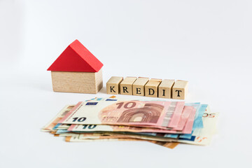 Word "loan" written with wooden blocks on white background "kredit" means "loan" in german