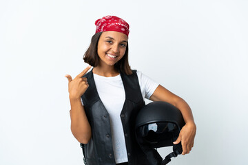 Young woman holding a motorcycle helmet isolated on white giving a thumbs up gesture