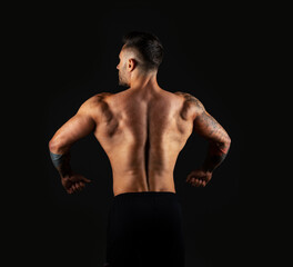 Fototapeta na wymiar Strong man view back. Bodybuilder on black background.