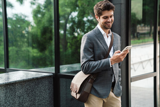 Optimistic Handsome Business Man Using Mobile Phone