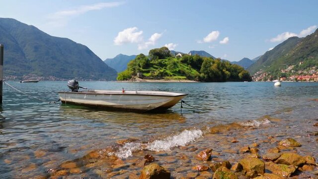 Great sunny day on Como lake. Picturesque morning landscape of Comocina island from the hiil of Ossuccio village, Province of Como, region Lombardy, Italy, Europe. Full HD video (High Definition).