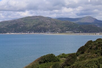 Fototapeta premium A view across the mouth of the Mawddach River past Fairbourne to Barmouth, Gwynedd, Wales, UK.