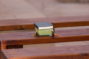 Two holy books lie on church bench in the Deir Al-Mukhraqa Carmelite Monastery building  in...