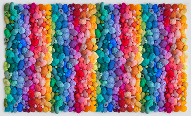 Colored balls and skiens of yarn for knitting. Top view. Rainbow colors. Color vertical gradient.