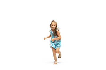 Happy child, little and emotional caucasian girl jumping and running isolated on white background. Looks happy, cheerful, sincere. Copyspace for ad. Childhood, education, happiness concept.