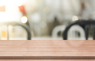 Empty wooden table top on blur coffee shop background