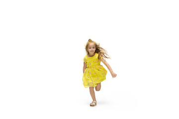 Happy child, little and emotional caucasian girl jumping and running isolated on white background. Looks happy, cheerful, sincere. Copyspace for ad. Childhood, education, happiness concept.