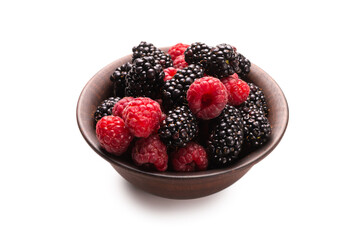 Raspberry, blackberry and mint leaf in ceramic brown bowl isolated on white