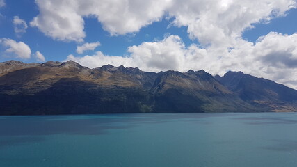 Fototapeta premium Lake Wakatipu with mountain view and clouds in summer, located in the southwest corner of the Otago region, in the South Island of New Zealand