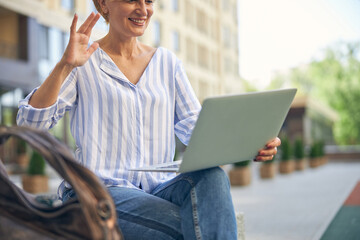 Smiling pleased lady making a video call