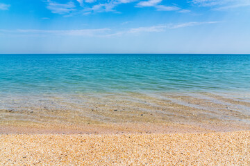 Calm clear blue sea and white sand beach