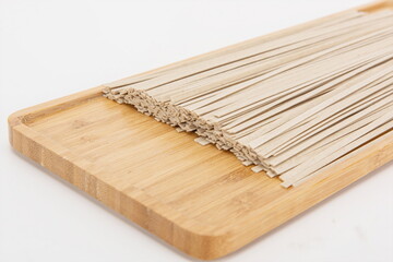 Dried noodles made of buckwheat on a white background