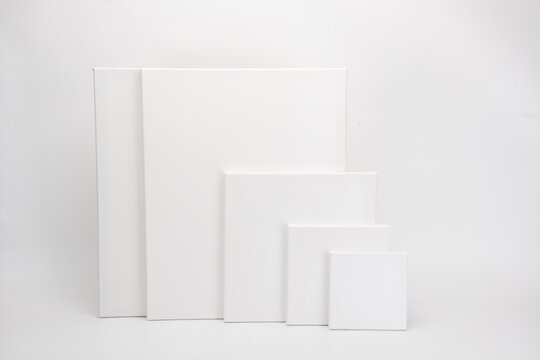 Blank oil canvases of different sizes on a grey background