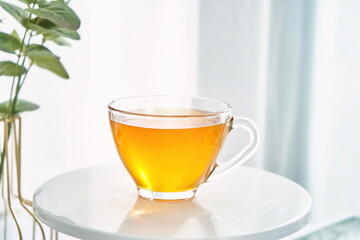 Golden honey in a clear glass, home scene