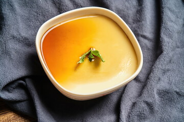 Homemade caramel custard pudding, mint in a vintage background
