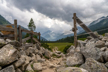 small path that goes through a wooden gate in the Dolomites