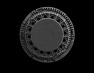 Metal sewer manhole on a black background