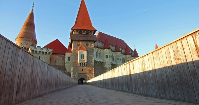 Morning view of Hunyad Castle / Corvin's Castle. Summer cityscape of Hunedoara town, Transylvania, Romania, Europe. Romanian castle landmarks. 4K video (Ultra High Definition).