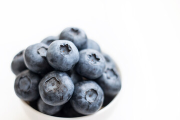 Fresh blueberry close-up isolated on a white background. Shallow depth of field. Healthy and dietary food concept. Fresh berries.