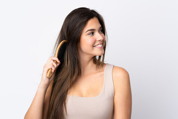 Teenager Brazilian girl with hair comb over isolated background