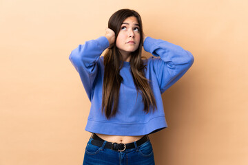 Teenager Brazilian girl over isolated background frustrated and covering ears